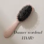 Haarborstel met losse haren en tekst Dunner wordend haar?