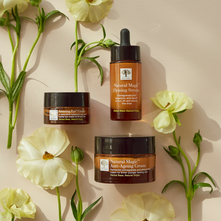 Natural Magic™ skincare lijn omringd door bloemen.